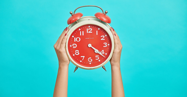 A person holding a clock