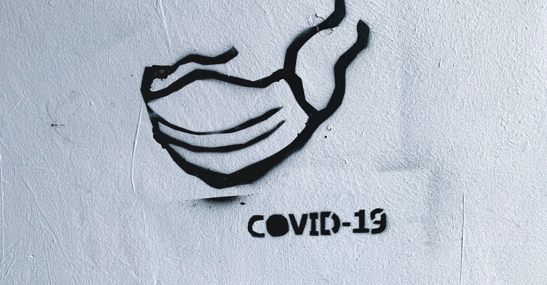 Photo of graffiti of person wearing Covid 19 mask